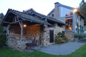 a stone house with a window on top of it at Le Fournil de Hourt in Vielsalm