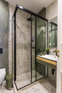 a bathroom with a shower and a sink at Kookaki Athens City Stay by Raise in Athens
