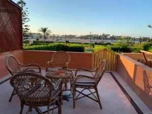 a patio with a table and chairs on a balcony at Marina 2 chalet lake front in El Alamein