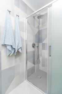 a shower with a glass door in a bathroom at Contrada del Nonno Apartments (city center - private parking on-site) in Rovinj