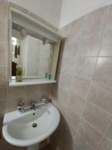 a bathroom with a sink and a mirror at La Dimora degli Dei in Piras