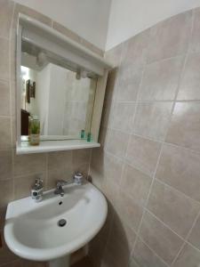 a bathroom with a sink and a mirror at La Dimora degli Dei 