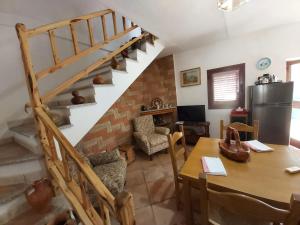 a living room with a table and a staircase at La Dimora degli Dei in Piras +47 photos