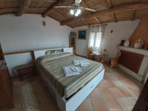 a bedroom with a large bed in a room at La Dimora degli Dei in Piras