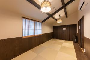a large room with wooden walls and a large window at 彩ホテル 紺 in Fukuoka