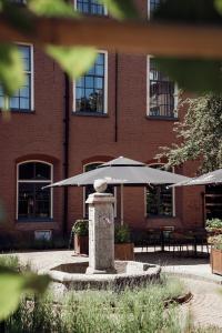 a brick building with tables and umbrellas in front of it at Broederenklooster in Zutphen