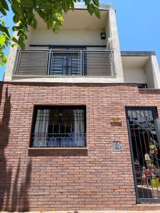 un edificio de ladrillo rojo con dos ventanas. en Depto cerca de Palmares Shopping Mall, en Godoy Cruz