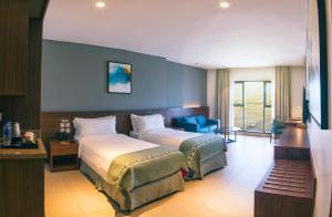 Ένα ή περισσότερα κρεβάτια σε δωμάτιο στο Boulevard Hotel Oman