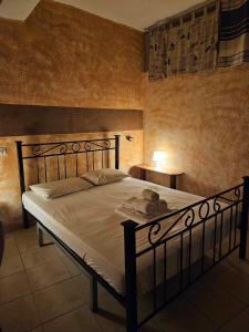 a bedroom with a large bed with white sheets at George's Guest House in Chania Town