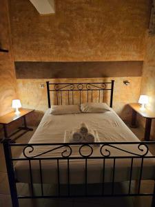 a bedroom with a bed with two lamps on tables at George's Guest House in Chania