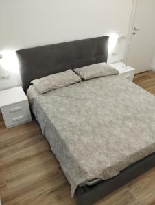 a bedroom with a large bed with two night stands at Le pergole in Olbia