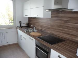a kitchen with a sink and a counter top at City Apartment WOB-Rothenfelde in Wolfsburg