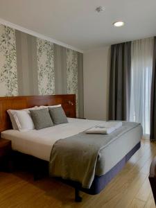 Ένα ή περισσότερα κρεβάτια σε δωμάτιο στο Hotel Vila Verde