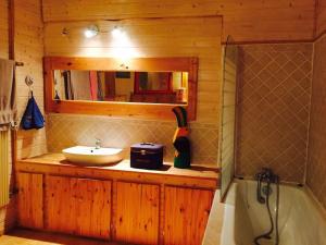 a bathroom with a sink and a mirror and a tub at Belle Maison en Bourgogne - Auxois - Morvan in Flée