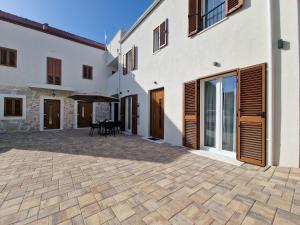 a courtyard of a house with a patio at Apartments Miamare in Primošten
