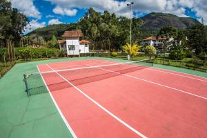 a tennis court in front of a house at Hotel Bucsky in Nova Friburgo