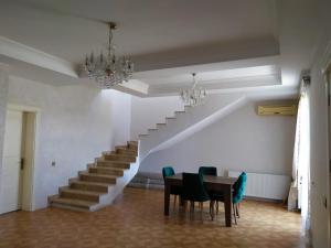 a dining room with a table and a staircase at Villa in Nakhchivan city, Azerbaijan in Naxçıvan