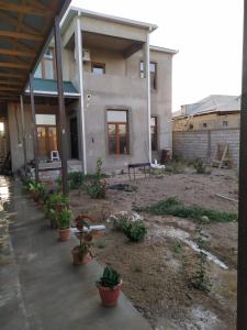 ein Haus mit Topfpflanzen davor in der Unterkunft Villa in Nakhchivan city, Azerbaijan in Nachitschewan