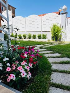 a garden with pink and red flowers in the grass at Agerola Dreams in Agerola
