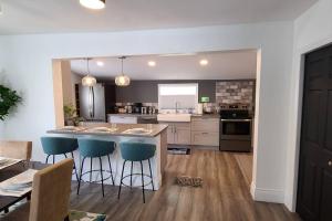 una cocina con una gran isla con taburetes de barra azul en Beautiful 2 Bedroom Home in the Heart of North Bay en North Bay