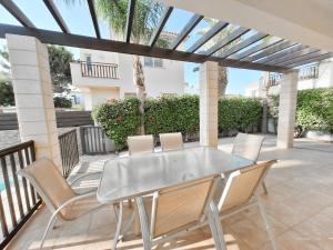 a glass table and chairs on a patio at Villa Lynn Chill Out Seaview in Ayia Napa