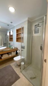 a bathroom with a shower and a toilet and a sink at Selena Luxury Monte Carrera in La Playa de Arguineguín