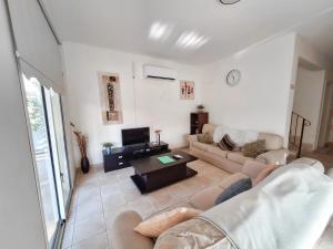 a living room with a couch and a table at Villa Lynn Chill Out Seaview in Ayia Napa