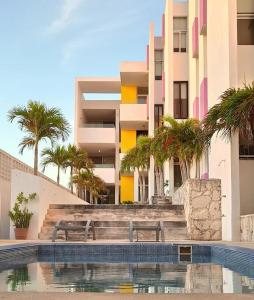 a swimming pool with a bench in front of a building at An amazing stay in Progreso, close to everything in Progreso