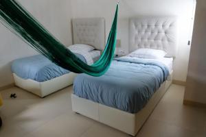 a bedroom with two beds with hammocks in it at An amazing stay in Progreso, close to everything in Progreso +52 photos