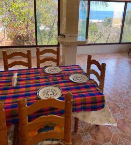 a table with plates on it in a room at Casa Blanca Zipolite, Dream House in Zipolite