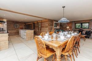 a dining room with a wooden table and chairs at Owl Barn in Oxford