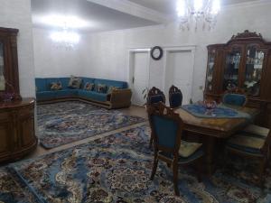 a living room with a blue couch and a table at House in Nakhchivan city, Azerbaijan in Naxçıvan