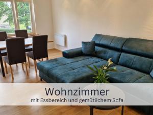 a living room with a couch and a table at Bergliebe - Gipfelstation in Blaichach