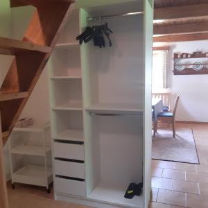 a room with a closet with white shelves at Chata Gerlinda in Kašperské Hory