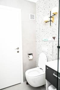 a white bathroom with a toilet and a sink at Dreambed 2 in Baia Mare +21 photos