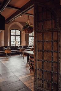a room with a table and a large wooden door at Broederenklooster in Zutphen +73 photos