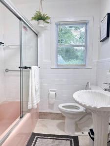 a white bathroom with a toilet and a sink at Sweet home Alabama in Huntsville