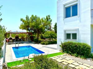 a swimming pool in the backyard of a house at Villa Papagiorgio Luxury and Harmony in Gennadi