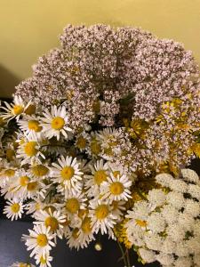 a bouquet of white and yellow flowers in a vase at Torgu Royal Guesthouse in Iide