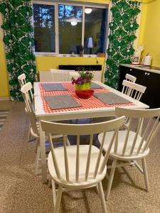 a dining room table and chairs with a table and a table and chairsktop at Torgu Royal Guesthouse in Iide