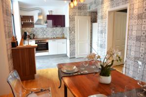 a kitchen and dining room with a wooden table at Apartment am Diako in Bremen
