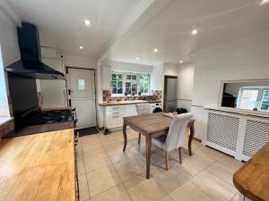 a kitchen with a wooden table and a dining room at Beautiful Room for ONE Person - free Netflix, Amazon Prime & Disney plus in Bromley