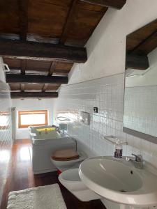 a bathroom with a toilet and a sink at San Marino Skyline - Suite Virgilio in San Marino