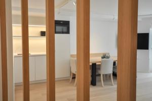 a room with a table and a dining room at Premium modern flat at Zoute Beach 2 bicylcles included in Knokke-Heist