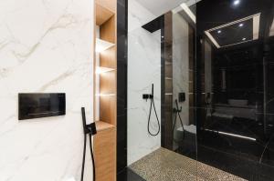 a bathroom with a shower with a glass door at Luxury apartment close to the city centre in Chişinău +26 photos
