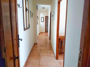a hallway with a long corridor with white walls at Ca l'Èndula in Lucena del Cid