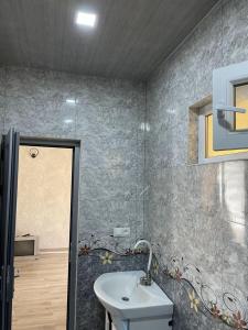 a bathroom with a sink and a mirror and a shower at Armani Hotel in Martuni