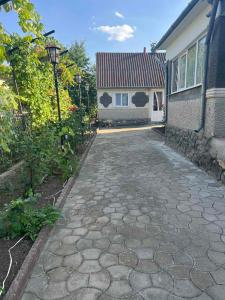 a stone walkway in front of a house at Гостевой дом in Ciorescu