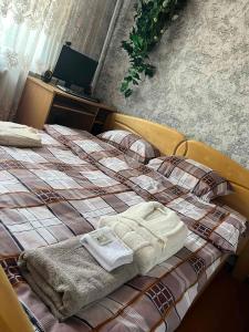 a bed with two towels sitting on top of it at Гостевой дом in Ciorescu