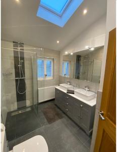 a bathroom with two sinks and a shower and a toilet at Near Woodbridge The Annexe Eyke Fantastic views with Dog secure Garden and Paddock in Eyke